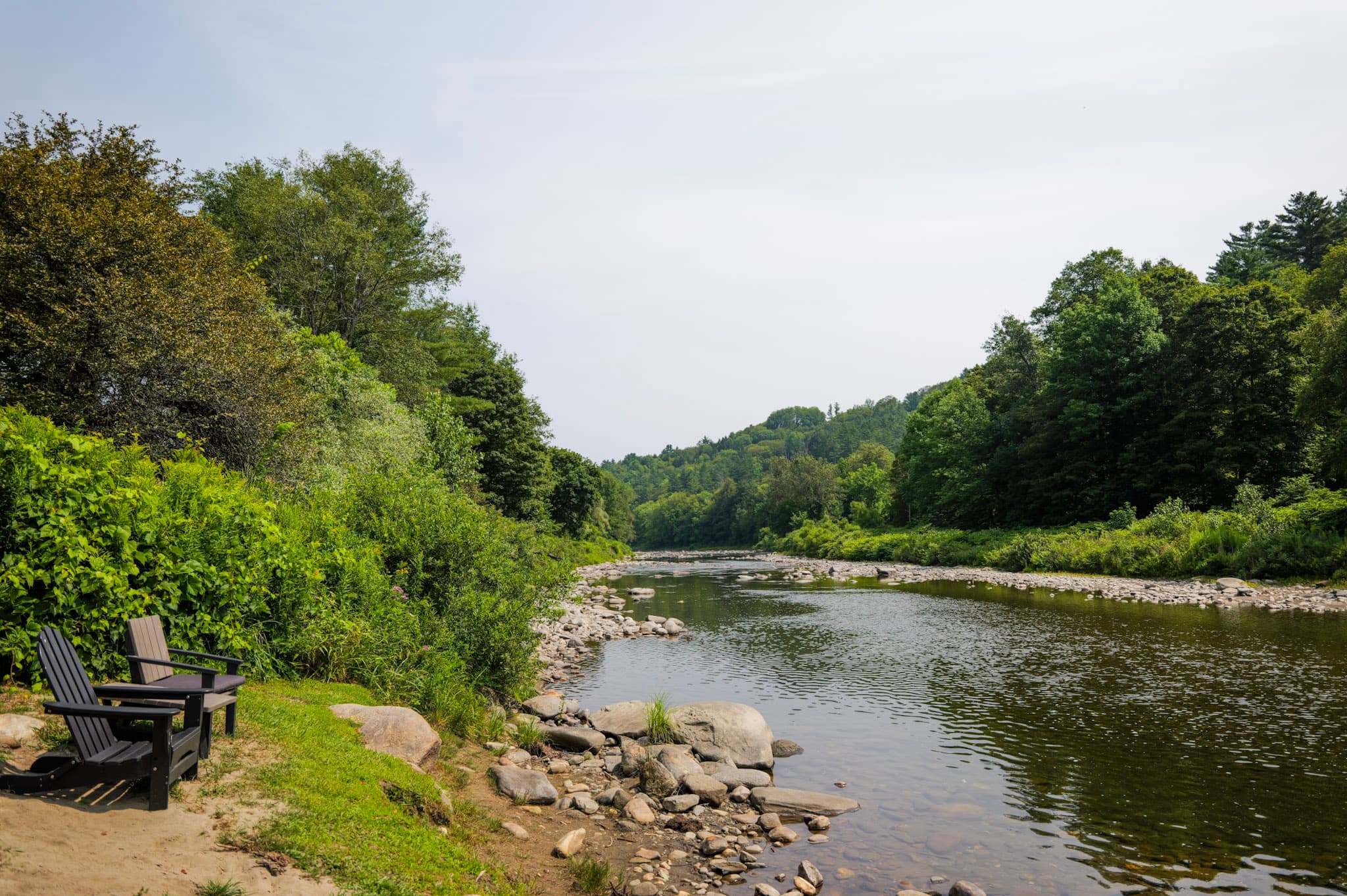 Adirondack chairs by a Vermont river